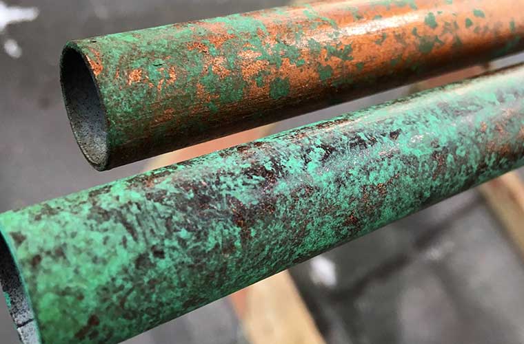 patina-and-verdigris-on-two-copper-pipes